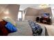 Relaxing bedroom featuring a plush bed, decorative pillows, TV, and a cozy reading nook for ultimate comfort at 723 New York Ave, St Cloud, FL 34769