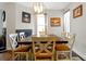 Warm dining room boasts a dark wood table, six chairs, fireplace, and elegant lighting creating a cozy atmosphere at 723 New York Ave, St Cloud, FL 34769