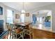 Open-concept dining area with a wooden table, six chairs, fireplace, and adjacent kitchen featuring blue cabinets at 723 New York Ave, St Cloud, FL 34769