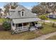 Charming two-story home boasts a welcoming front porch and mature landscaping at 723 New York Ave, St Cloud, FL 34769