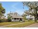 Charming two-story home with a welcoming front porch, complemented by mature trees and a well-maintained lawn at 723 New York Ave, St Cloud, FL 34769