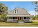 Charming two-story home featuring a cozy front porch, bright yellow door, and beautifully landscaped front yard at 723 New York Ave, St Cloud, FL 34769
