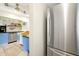 Updated kitchen with wood floors, blue cabinets, stainless steel appliances, and a modern refrigerator at 723 New York Ave, St Cloud, FL 34769