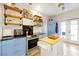 Stylish kitchen features wood floors, stainless steel appliances, and a kitchen island at 723 New York Ave, St Cloud, FL 34769