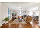 Open-concept living room with hardwood floors, fireplace, and view of the adjacent dining area at 723 New York Ave, St Cloud, FL 34769