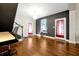 Stylish living room features hardwood floors, contrasting wall colors, and bright window at 723 New York Ave, St Cloud, FL 34769