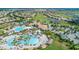 Aerial view of community pool, clubhouse, and surrounding homes at 771 Drop Shot Dr, Davenport, FL 33896