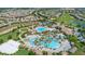 Aerial view of community with resort-style pool, clubhouse, and lush landscaping at 771 Drop Shot Dr, Davenport, FL 33896