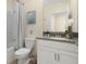 Bathroom with tub shower combo and gray vanity at 771 Drop Shot Dr, Davenport, FL 33896