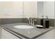 Modern bathroom with gray countertop and updated fixtures at 771 Drop Shot Dr, Davenport, FL 33896