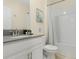 Clean bathroom with tub shower combo and gray vanity at 771 Drop Shot Dr, Davenport, FL 33896