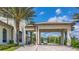 Community entrance with covered walkway and palm trees at 771 Drop Shot Dr, Davenport, FL 33896