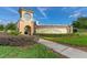 ChampionsGate community entrance with clock tower and landscaping at 771 Drop Shot Dr, Davenport, FL 33896
