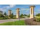 Grand entrance to ChampionsGate community featuring pillars and signage at 771 Drop Shot Dr, Davenport, FL 33896