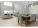 Open concept dining room with modern chandelier and seating for eight at 771 Drop Shot Dr, Davenport, FL 33896
