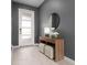 Modern entryway featuring a console table, mirror, and stylish decor at 771 Drop Shot Dr, Davenport, FL 33896