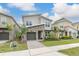 Modern home with stone exterior and palm trees in front at 771 Drop Shot Dr, Davenport, FL 33896