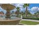 Close-up view of a fountain with palm trees in the background at 771 Drop Shot Dr, Davenport, FL 33896