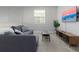 Spacious game room with sofa, coffee table, and TV at 771 Drop Shot Dr, Davenport, FL 33896