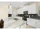 Modern kitchen with island and stainless steel appliances at 771 Drop Shot Dr, Davenport, FL 33896