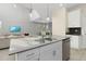 Modern kitchen island with double sink, stainless steel appliances, and ample counter space at 771 Drop Shot Dr, Davenport, FL 33896