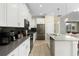 Modern kitchen with island and stainless steel appliances at 771 Drop Shot Dr, Davenport, FL 33896