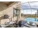 Outdoor patio dining area with seating for four, adjacent to the pool and spa at 771 Drop Shot Dr, Davenport, FL 33896