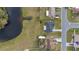 Overhead view of the property, near a pond, showcasing the layout and proximity to surrounding homes at 83 Alameda Dr, Kissimmee, FL 34743