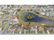 Sprawling aerial shot showcasing the home's location near a picturesque pond and friendly neighborhood at 83 Alameda Dr, Kissimmee, FL 34743