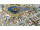 Aerial view of a residential neighborhood featuring a central pond and well-maintained homes at 83 Alameda Dr, Kissimmee, FL 34743