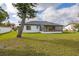 The house's white exterior is complemented by a spacious yard, ideal for outdoor enjoyment at 83 Alameda Dr, Kissimmee, FL 34743