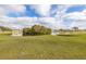 Picturesque backyard with a serene pond view and lush green grass at 83 Alameda Dr, Kissimmee, FL 34743