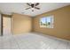Bedroom with tile flooring, ceiling fan and a window that offers plenty of natural light at 83 Alameda Dr, Kissimmee, FL 34743