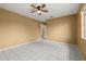 Bedroom with tile flooring, ceiling fan and a window that offers plenty of natural light at 83 Alameda Dr, Kissimmee, FL 34743
