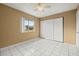 Bedroom with tile flooring, closet and a window that offers plenty of natural light at 83 Alameda Dr, Kissimmee, FL 34743