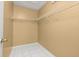 Walk-in closet with built-in shelving and neutral colored walls with tile flooring at 83 Alameda Dr, Kissimmee, FL 34743