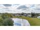 Scenic view of the backyard pond, with the house and surrounding greenery in the background at 83 Alameda Dr, Kissimmee, FL 34743