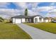 Attractive single-story home with well-kept lawn and a long driveway, inviting curb appeal at 83 Alameda Dr, Kissimmee, FL 34743