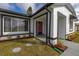 Inviting front entrance with decorative landscaping, a charming red door, and neutral-colored exterior at 83 Alameda Dr, Kissimmee, FL 34743