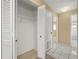 Hallway with tile flooring and a linen closet offers easy access to the bathroom at 83 Alameda Dr, Kissimmee, FL 34743
