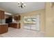 Kitchen with tile floors, dark cabinetry, and sliding glass doors to a screened patio at 83 Alameda Dr, Kissimmee, FL 34743