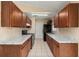 Kitchen with dark cabinets, stainless steel appliances, and neutral countertops at 83 Alameda Dr, Kissimmee, FL 34743
