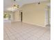 Open living room features tile floors, high ceilings, and a ceiling fan at 83 Alameda Dr, Kissimmee, FL 34743