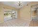 Spacious, airy living room features tile flooring and sliding doors to the screened patio at 83 Alameda Dr, Kissimmee, FL 34743