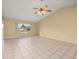 Bright living room featuring tile floors, ceiling fan, and a large window providing natural light at 83 Alameda Dr, Kissimmee, FL 34743