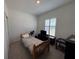 Bright bedroom with a twin bed and large window at 835 Griffon Ave, Lake Alfred, FL 33850