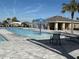 Community pool with water feature and lounge chairs at 835 Griffon Ave, Lake Alfred, FL 33850