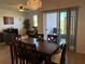 Dining room with dark wood table and chairs, view to patio at 835 Griffon Ave, Lake Alfred, FL 33850