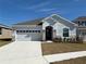 Two-story house with a two-car garage and stone accents at 835 Griffon Ave, Lake Alfred, FL 33850