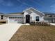 Single-story home with white exterior, stone accents, and a two-car garage at 835 Griffon Ave, Lake Alfred, FL 33850